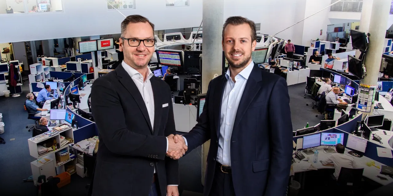 Roland Schmid, Eigentümer und Geschäftsführer der IMMOunited GmbH, und Niki Fellner, Geschäftsführer der oe24 media group, besiegeln die neue strategische Medienpartnerschaft zwischen IMMOunited und oe24