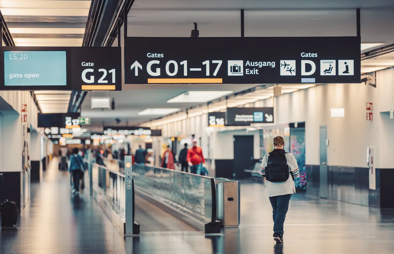 Peoples walking and carries luggage in Vienna airport terminal